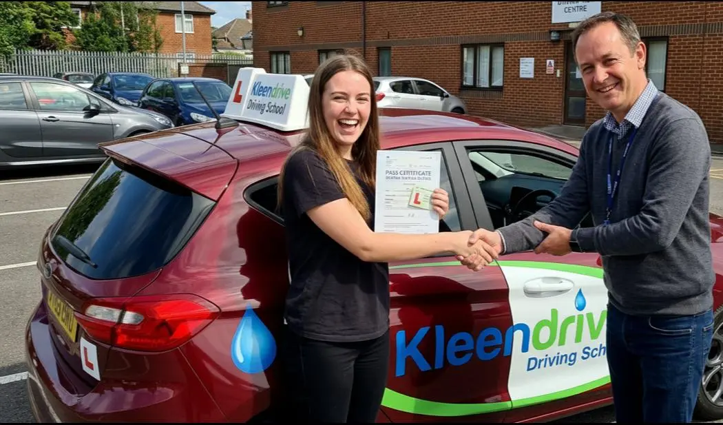 Smiling student celebrating passing his driving test